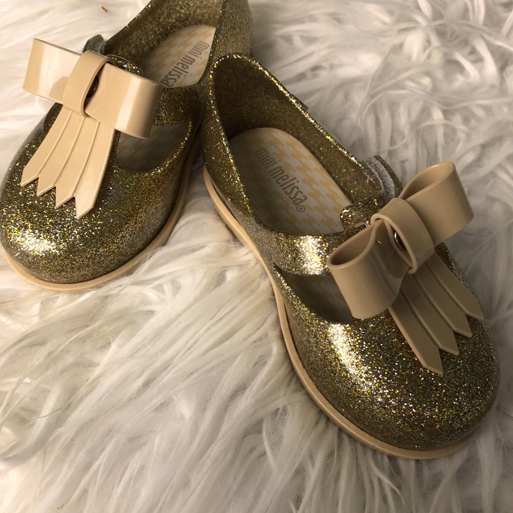New adorable Mini Melissa gold size 7 child’s shoe.